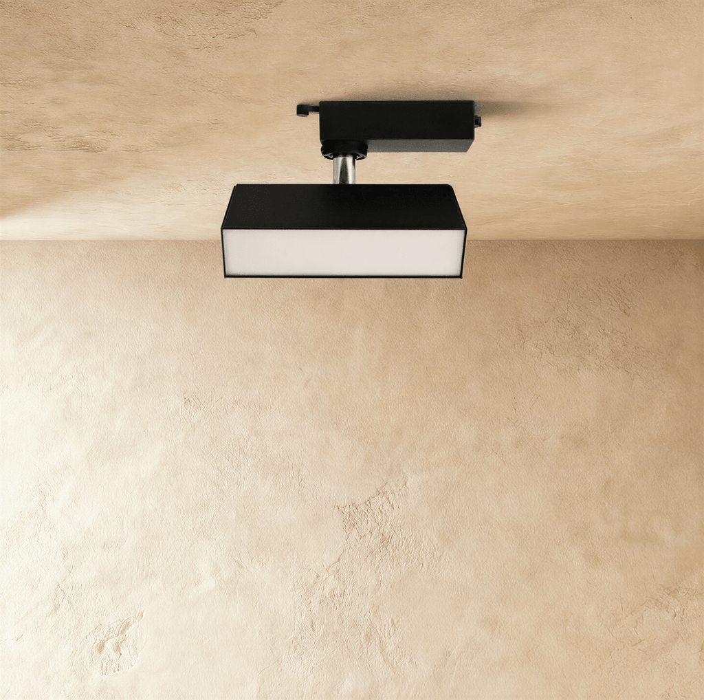 Clérachic short black rectangular track light with a frosted diffuser face, tilting on a chrome stem from a track adaptor.