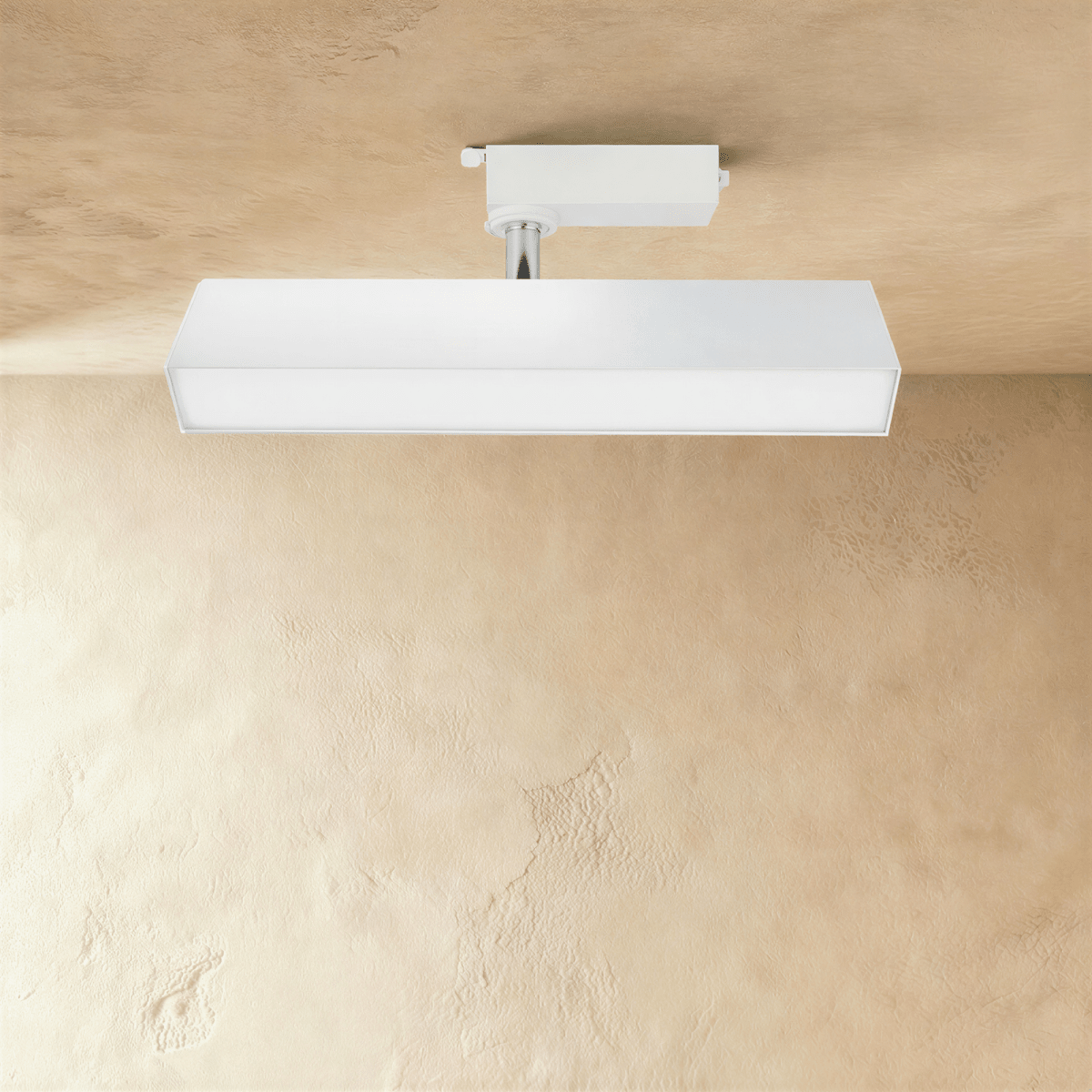 Clérachic medium white rectangular linear track light with a long frosted diffuser, hung from a track adaptor on a chrome stem.