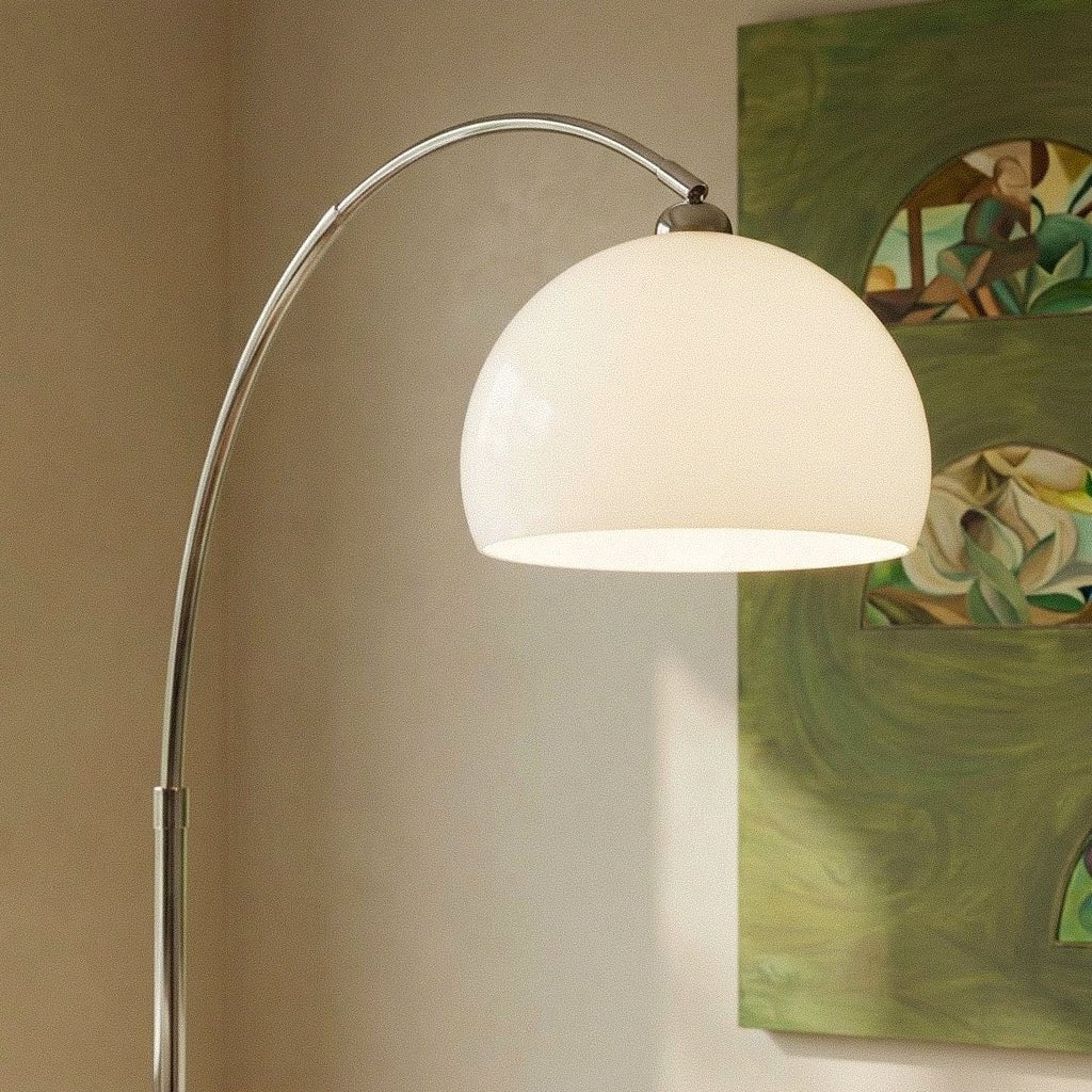 A close view of the white dome shade on this Clérachic floor lamp, set against a colourful framed artwork.
