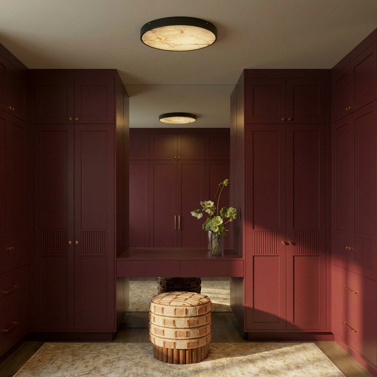 Clérachic marble-diffuser ceiling lights lit in a burgundy dressing room, one overhead and one reflected in the mirror.