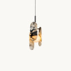 Three oval marble panels with black veining wrap a frosted glass globe on a slim black stem, on a plain white backdrop, from Clérachic.
