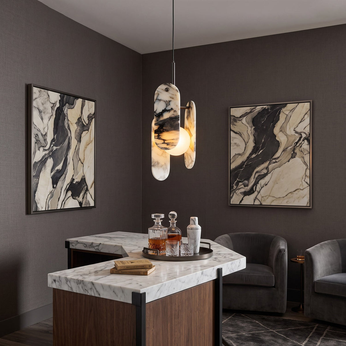 A Clérachic marble pendant hangs over a marble-topped bar with a drinks tray, between two framed marbled artworks.