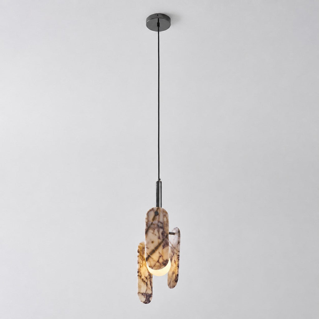 The Clérachic pendant in a cream marble version with violet veining, hung from a black cord and canopy on a pale backdrop.