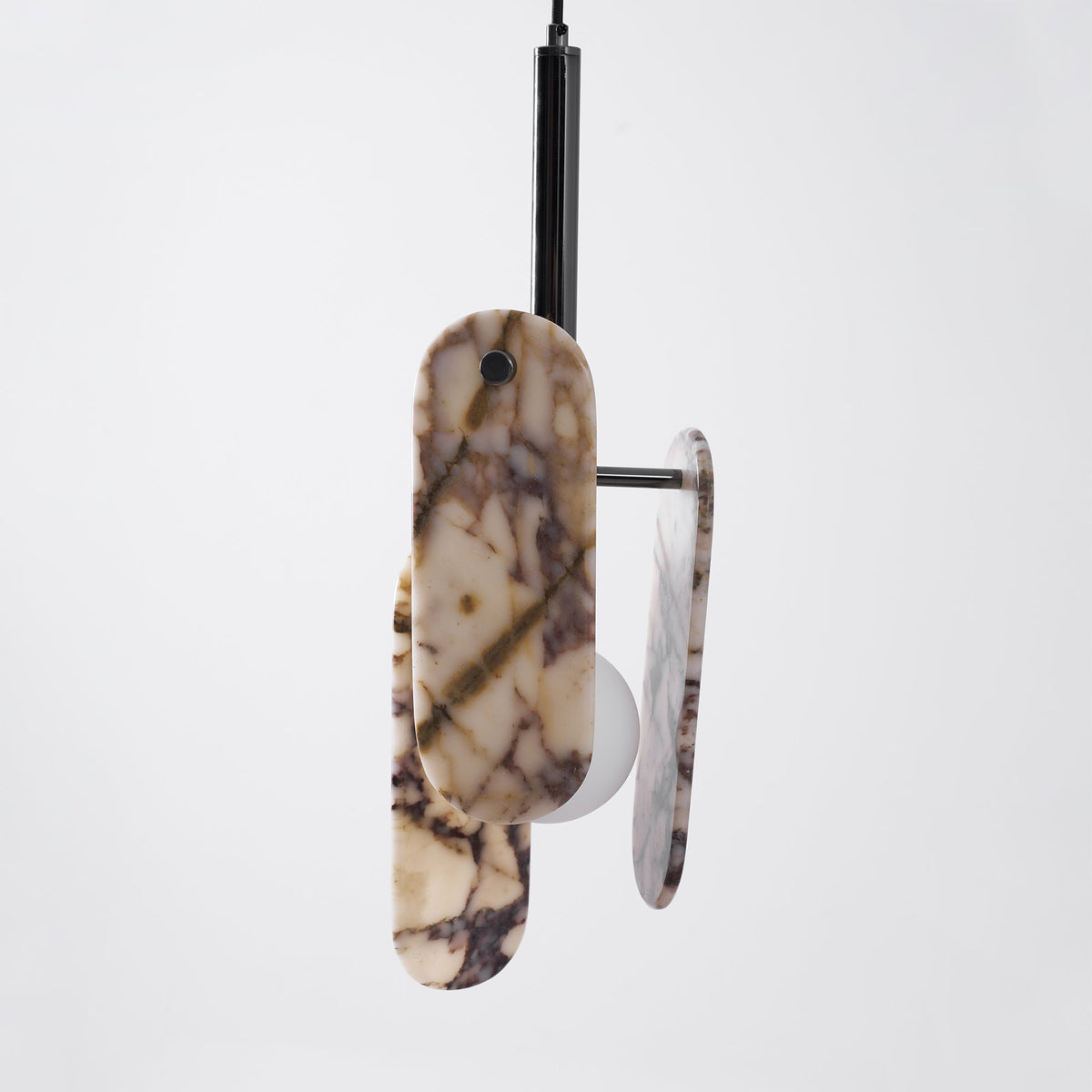 Side view of this Clérachic pendant in a cream marble version, with a black stem and arms between the oval stone panels.