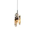 A Clérachic marble pendant in black and white, lit warm behind its oval panels, on a black cord against a plain white backdrop.