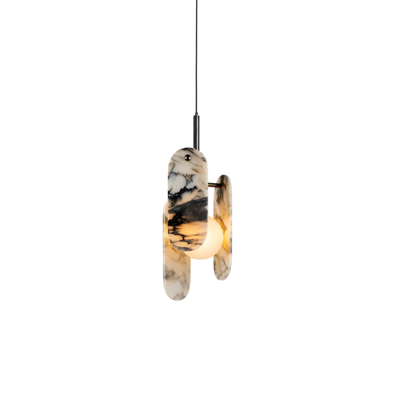 A Clérachic marble pendant in black and white, lit warm behind its oval panels, on a black cord against a plain white backdrop.