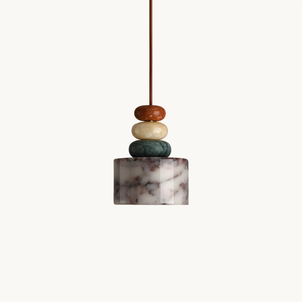 Clérachic pendant on a plain white backdrop, a veined marble drum shade below three stacked stone beads in rust, cream and green.
