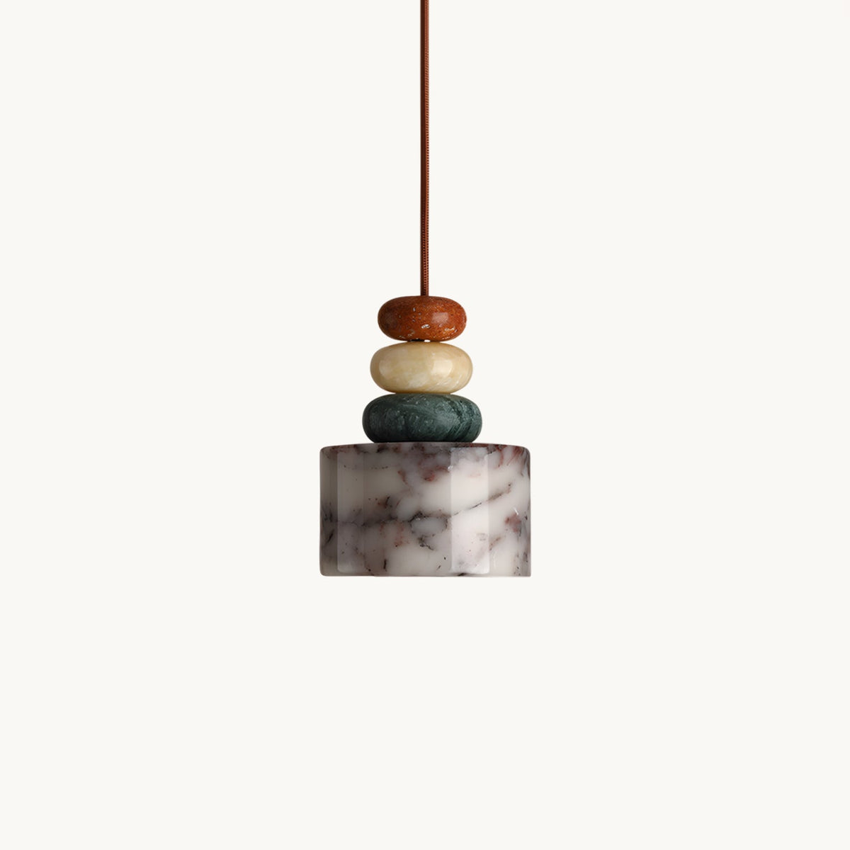 Clérachic pendant on a plain white backdrop, a veined marble drum shade below three stacked stone beads in rust, cream and green.