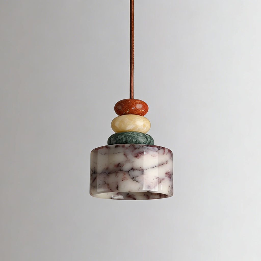 Unlit Clérachic pendant against a soft grey backdrop, showing the white marble drum with plum-coloured veining under three stone beads.
