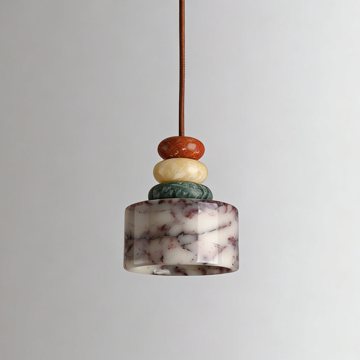 Unlit Clérachic pendant against a soft grey backdrop, showing the white marble drum with plum-coloured veining under three stone beads.