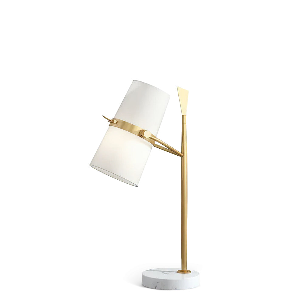 A Clérachic table lamp with a gold stem and white marble base, the white shade tilted to the left, shown on a plain white background.