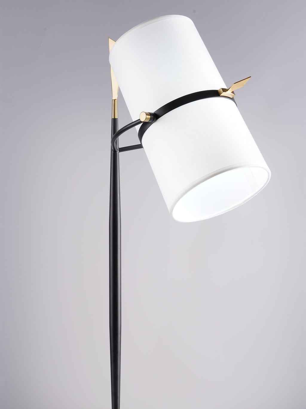 Low, close view of the large white shade on this Clérachic lamp, tipped right on its black stem against a lilac-grey backdrop.