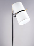 Low, close view of the large white shade on this Clérachic lamp, tipped right on its black stem against a lilac-grey backdrop.