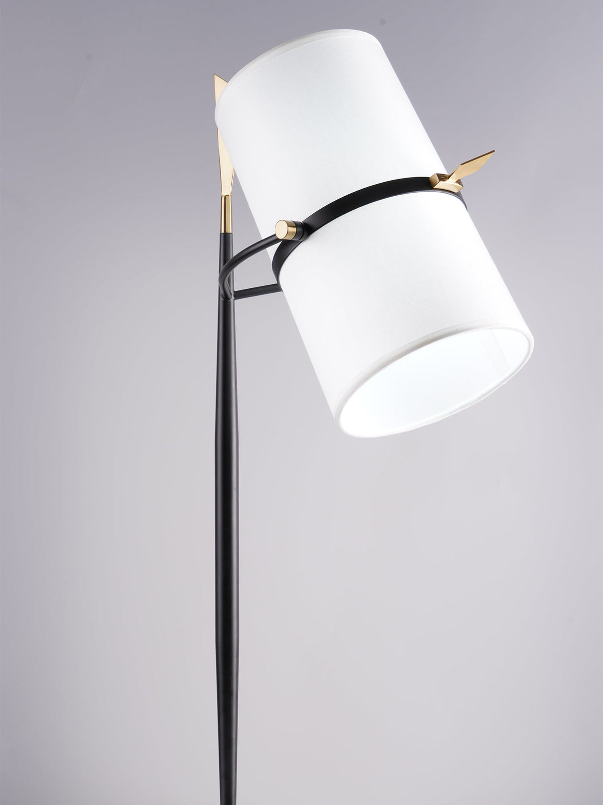 Low, close view of the large white shade on this Clérachic lamp, tipped right on its black stem against a lilac-grey backdrop.