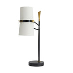 Black Clérachic table lamp with its white shade held upright and set to one side of the stem, on a round black base.