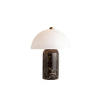 This Clérachic table lamp cut out on a white background, showing the white glass dome, small brass finial and dark marble stem.