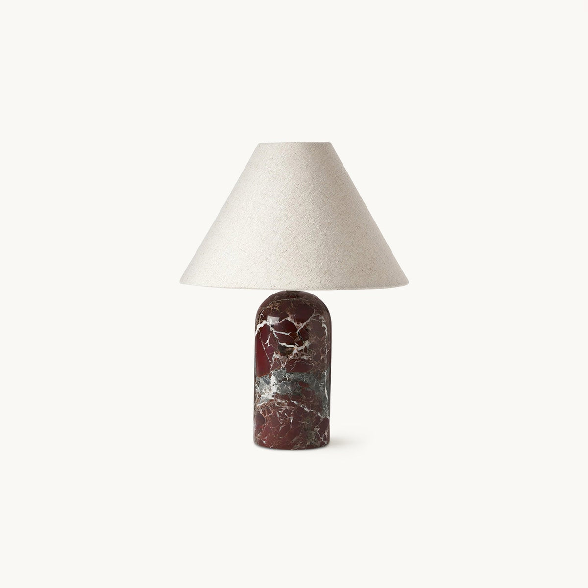 Linen cone shade on a deep burgundy marble base, this Clérachic table lamp shown unlit on a plain white backdrop.