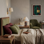 Bedroom with a green velvet armchair and olive headboard, where a small Clérachic table lamp sits on the bedside table.
