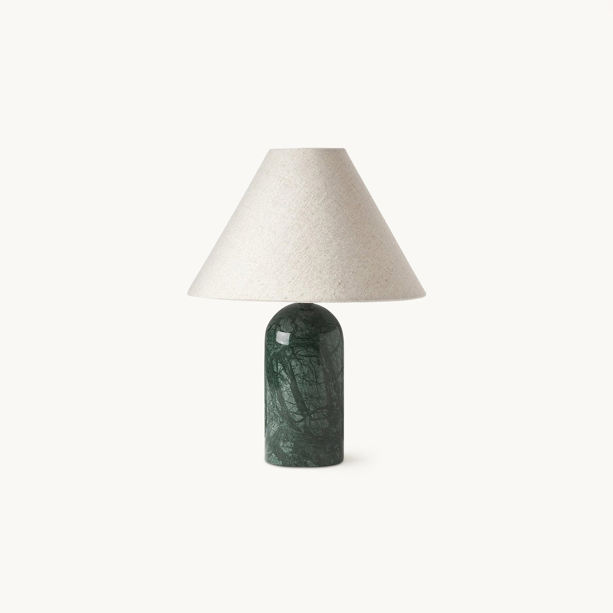 Dark green marble base and a pale linen cone shade, this Clérachic table lamp in a straight-on view against a clean white backdrop.