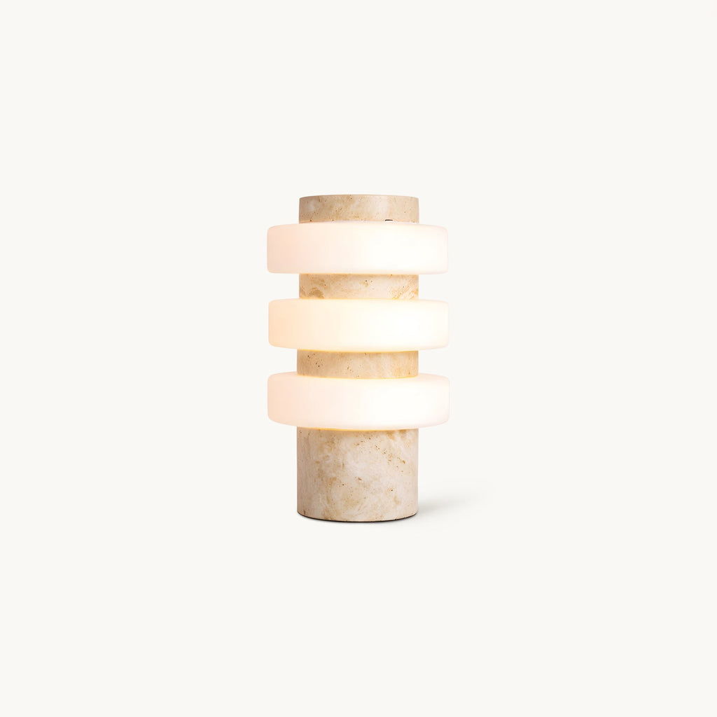 Front view of this Clérachic table lamp on a plain white backdrop, three frosted white glass discs stacked on a beige travertine column.