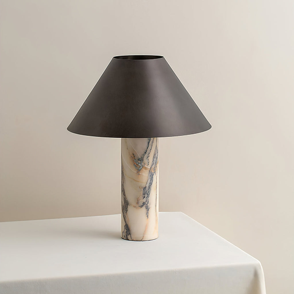 Front view of a Clérachic table lamp, unlit, showing the grey-veined cream marble column under a wide tapered shade.