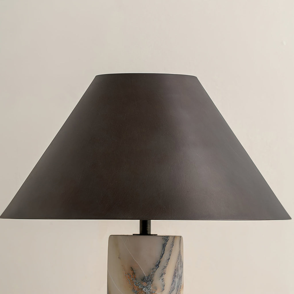 Close view of the tapered black shade and the veined marble top of the base on this Clérachic table lamp.