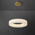 Clérachic Marika ring chandelier, a thick alabaster torus hung from a round brass canopy.