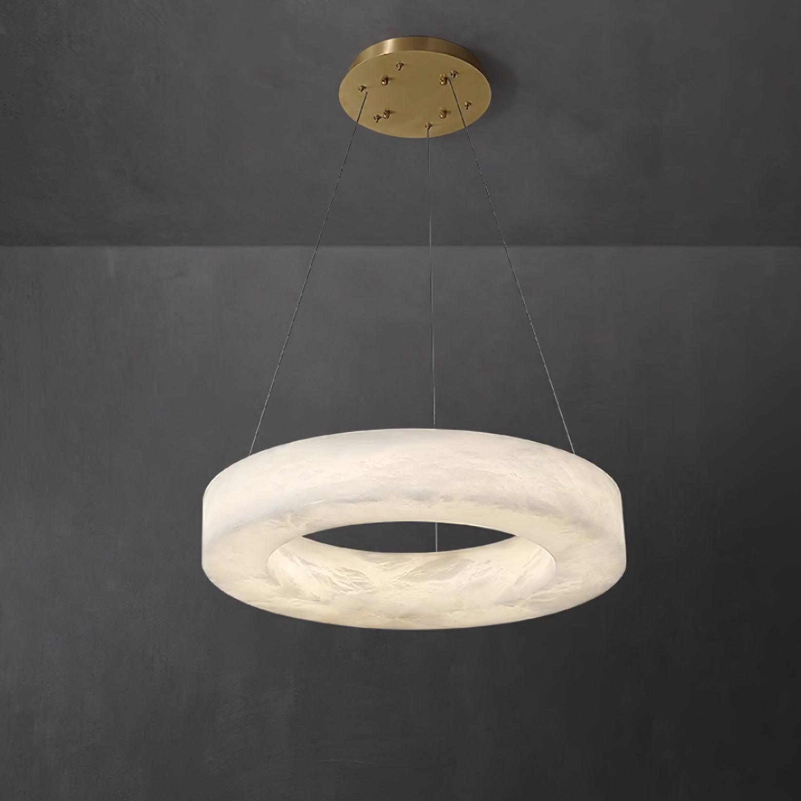 Clérachic Marika ring chandelier, a thick alabaster torus hung from a round brass canopy.