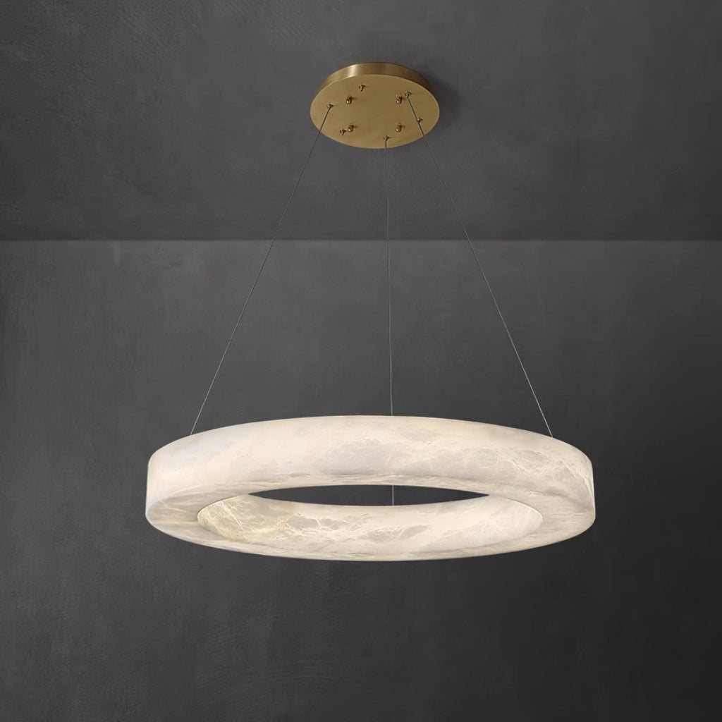 The Clérachic Marika ring on grey, its veined stone band lit softly all the way round.