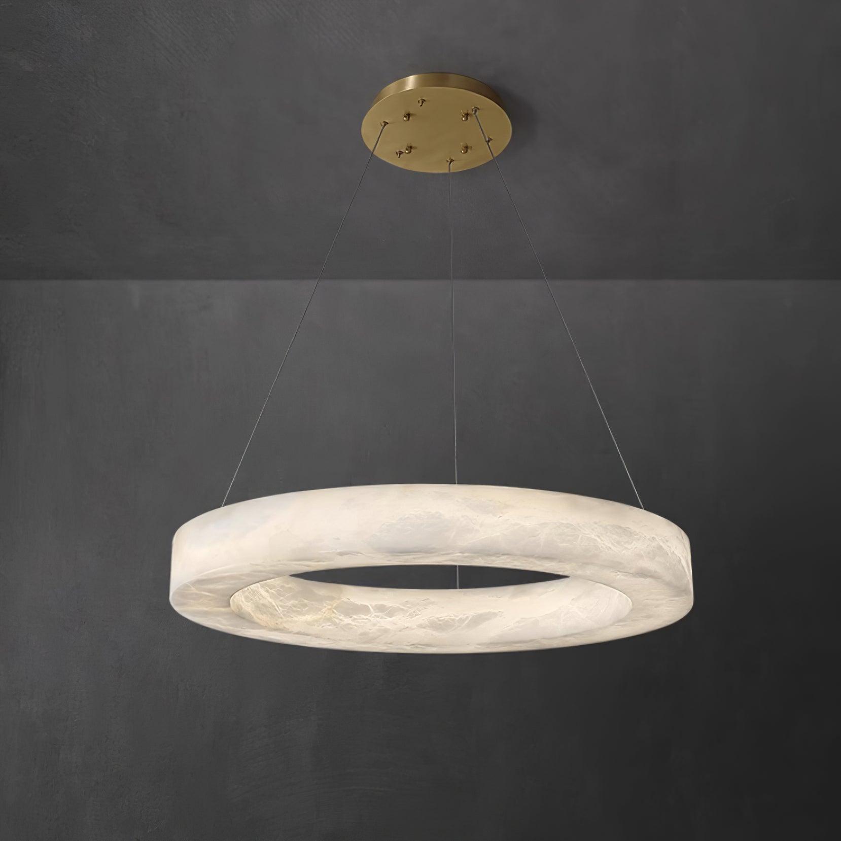 The Clérachic Marika ring on grey, its veined stone band lit softly all the way round.
