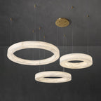 The layered Clérachic Marika set on grey, three alabaster rings hung at stepped drops.