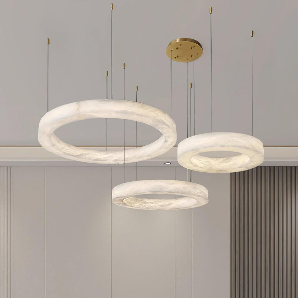 Three Clérachic Marika rings lit against pale panelling, the largest tilted forward.