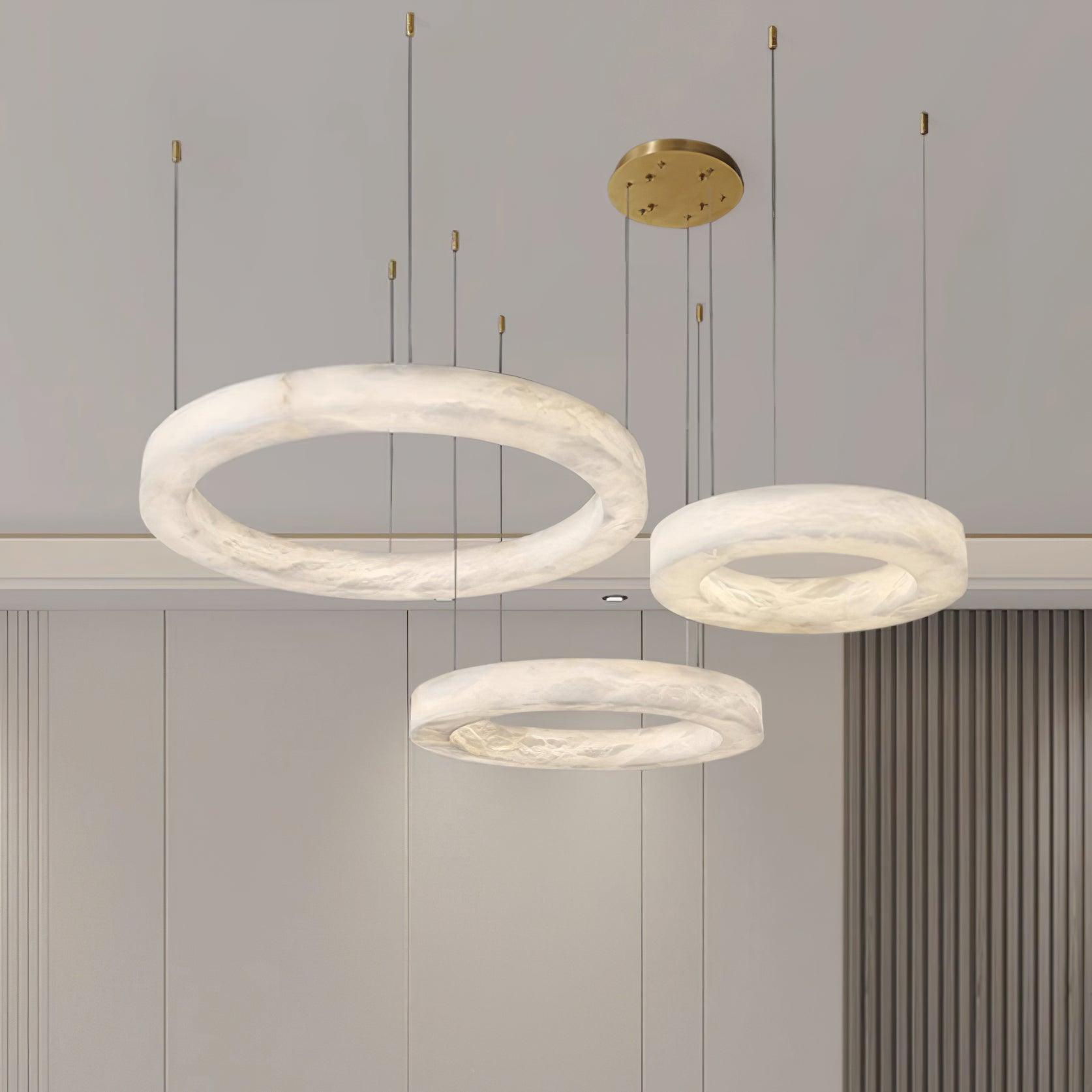 Three Clérachic Marika rings lit against pale panelling, the largest tilted forward.