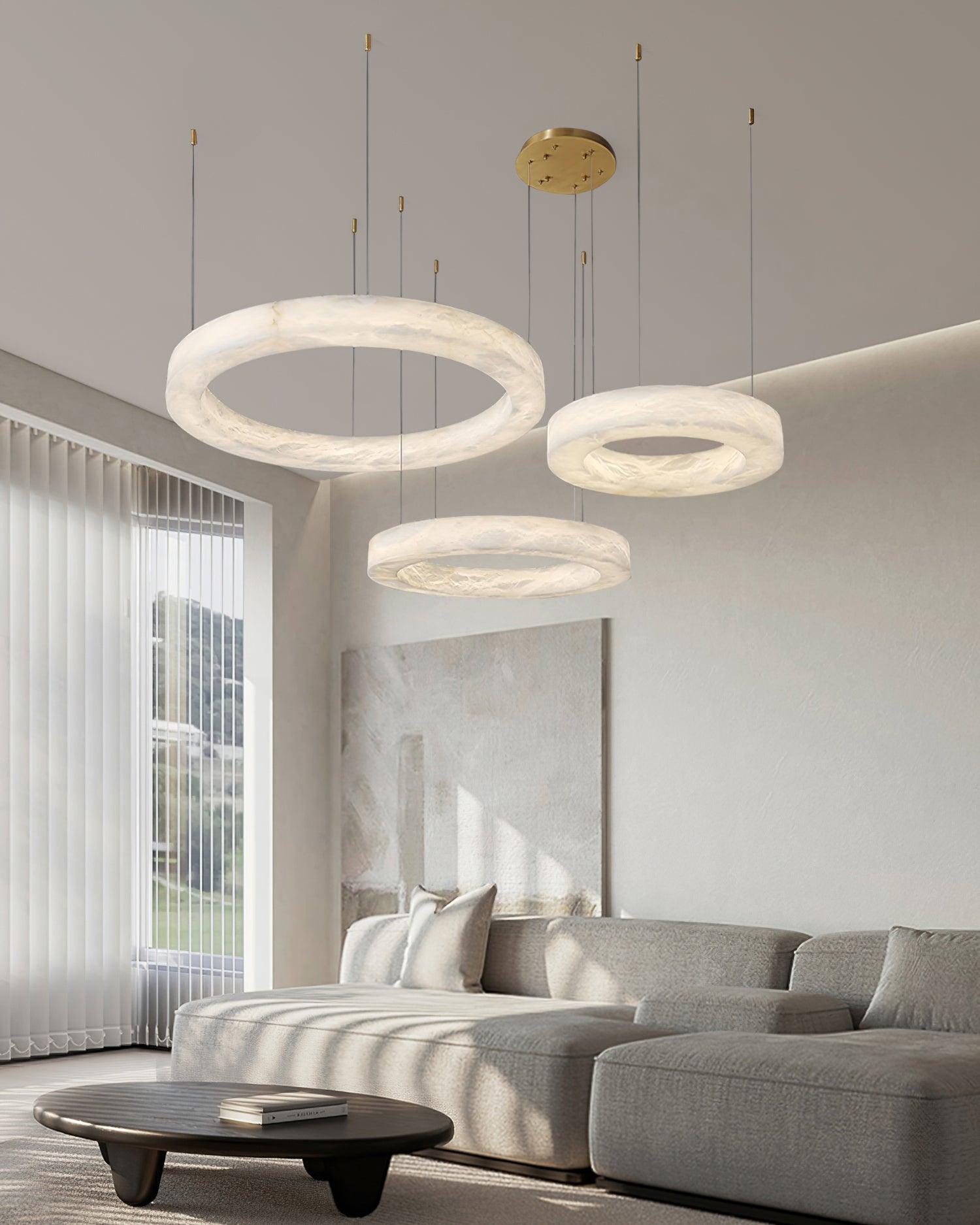 Clérachic Marika rings lit in a bright living room, sunlight raking across the wall behind.