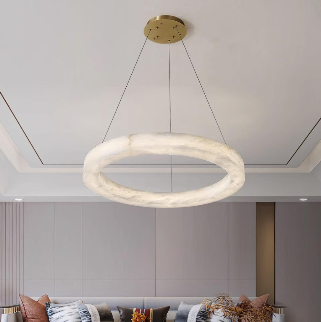 A single Clérachic Marika ring lit above a sofa in a grey panelled room.
