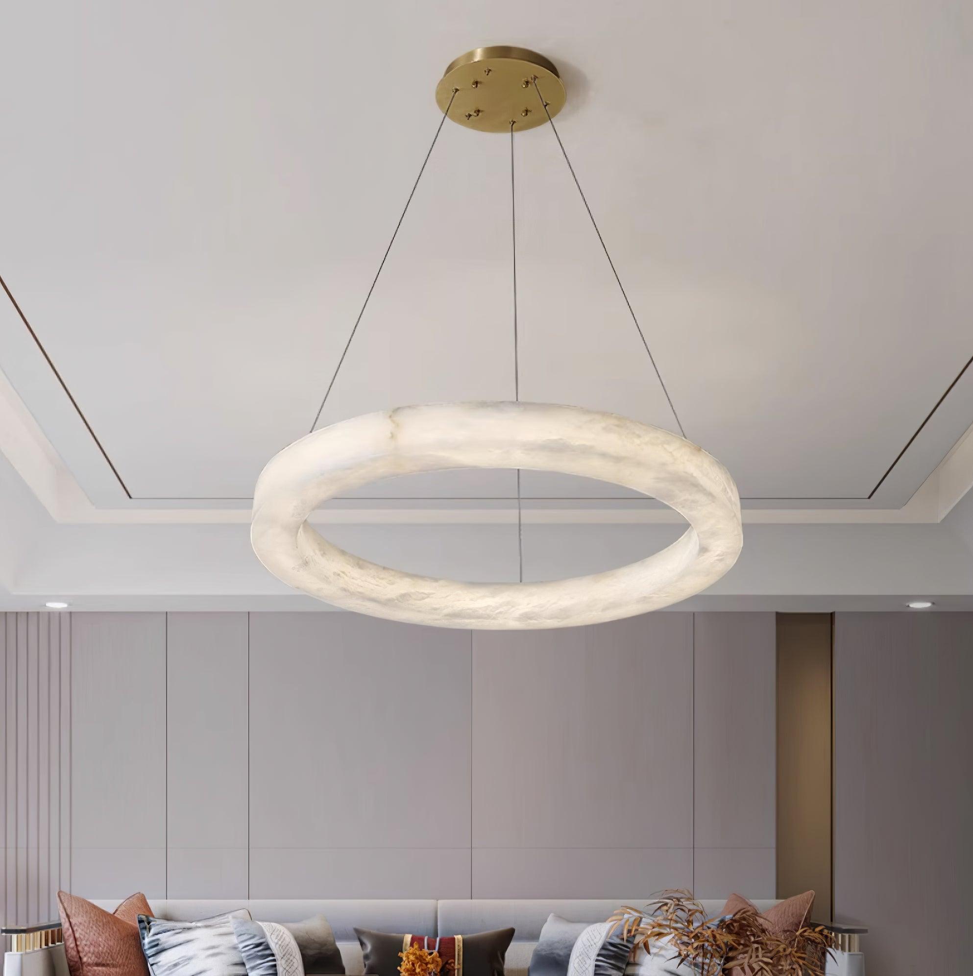 A single Clérachic Marika ring lit above a sofa in a grey panelled room.