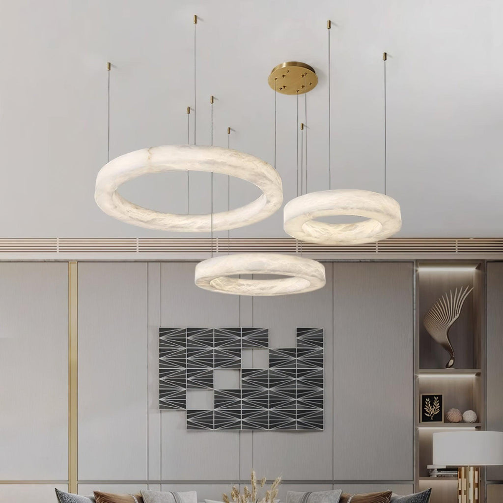 The Clérachic Marika three-ring set lit above a geometric wall artwork and console.