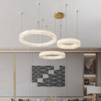 The Clérachic Marika three-ring set lit above a geometric wall artwork and console.