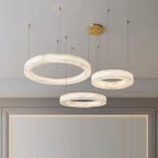 Clérachic Marika rings lit above a mirror in a pale panelled hallway.
