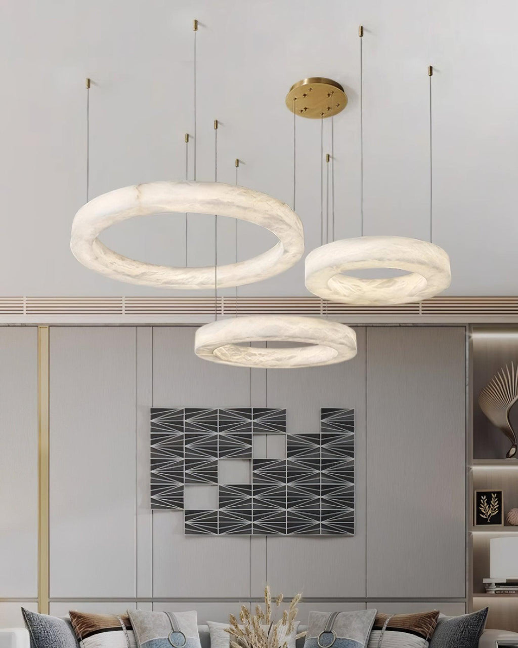 Clérachic Marika rings lit in a grey living room above a patterned sofa and dried stems.
