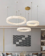 Clérachic Marika rings lit in a grey living room above a patterned sofa and dried stems.