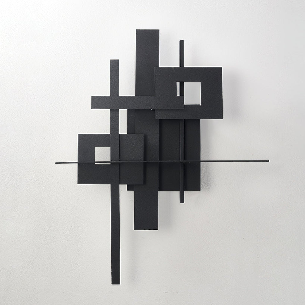 This Clérachic matt black wall light switched off, its overlapping panels, cutouts and thin bars shown on a pale wall.