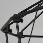 Close view of black matt connectors where the thin metal rods of this Clérachic chandelier frame meet.