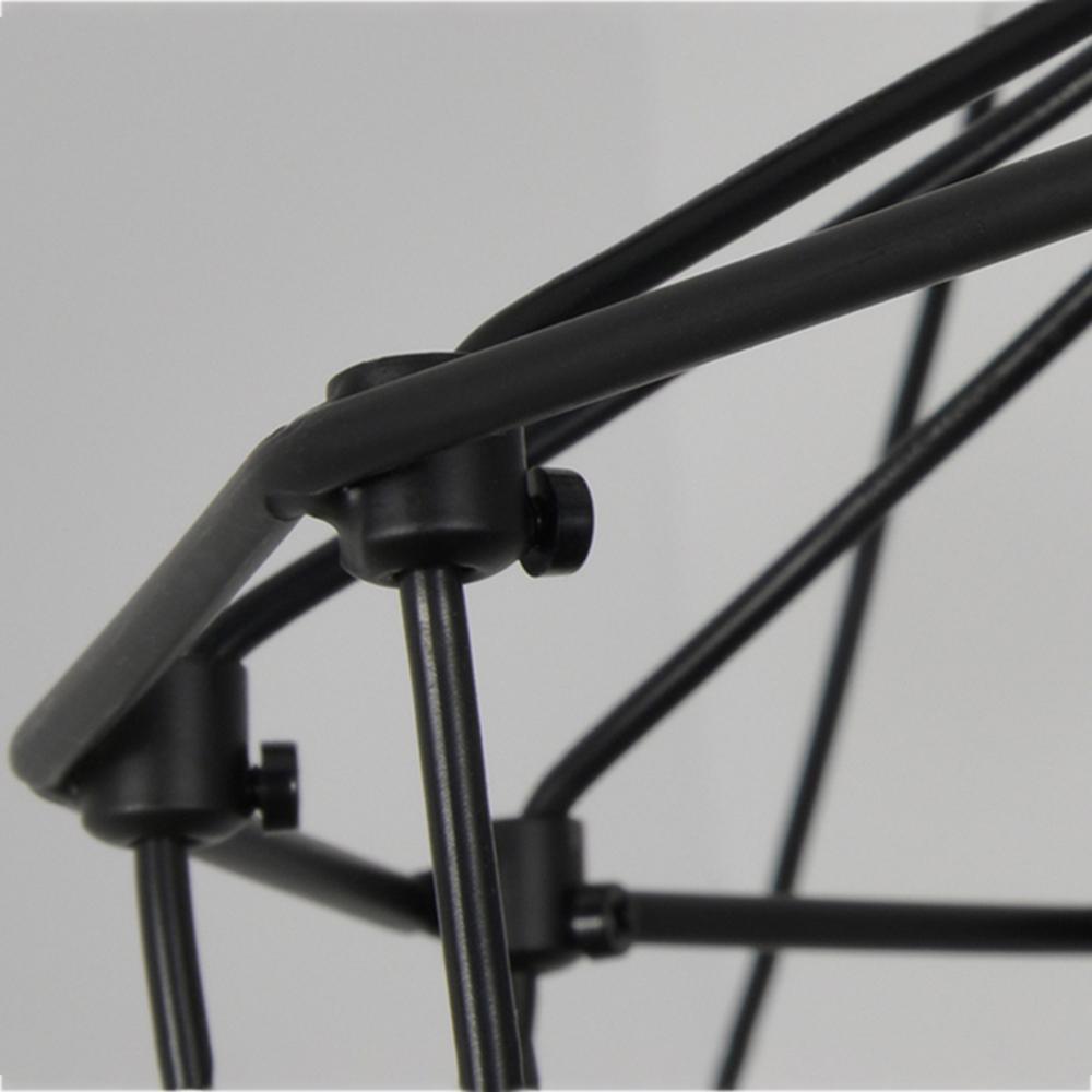 Close view of black matt connectors where the thin metal rods of this Clérachic chandelier frame meet.