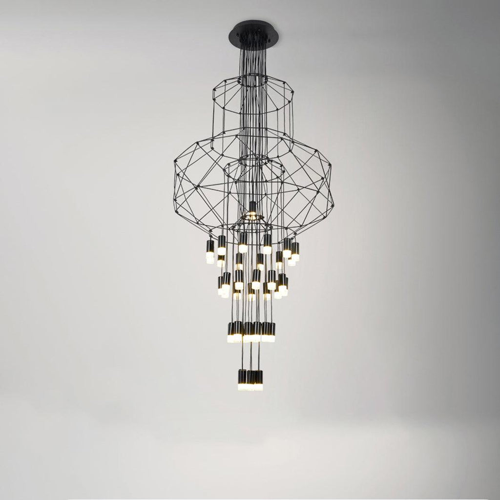 Stacked-frame Clérachic wire chandelier lit on a soft grey studio backdrop, with a long cluster of LED drops hanging beneath.