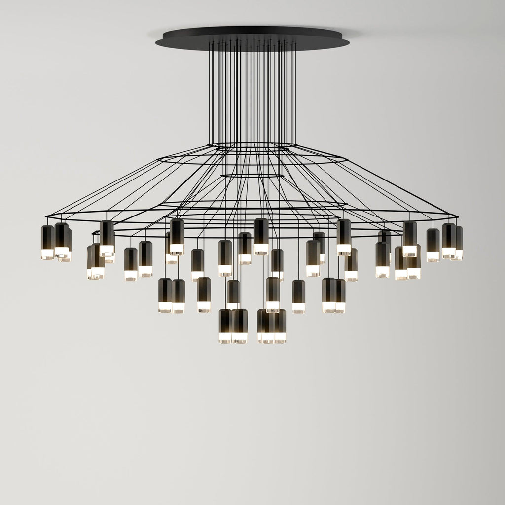 Wide, low Clérachic wire chandelier with a broad tiered frame and many LED drops of different lengths, hung from a round canopy.