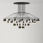 Wide, low Clérachic wire chandelier with a broad tiered frame and many LED drops of different lengths, hung from a round canopy.