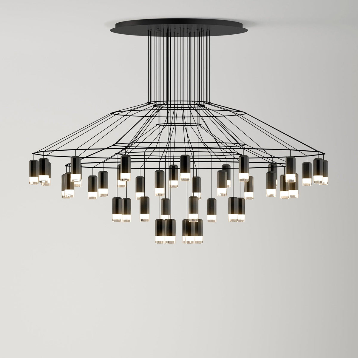 Wide, low Clérachic wire chandelier with a broad tiered frame and many LED drops of different lengths, hung from a round canopy.