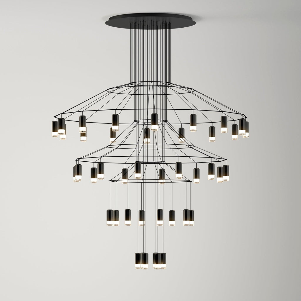 Three-tier Clérachic wire chandelier with ringed frames and LED drops stepping down towards a lit cluster at the bottom.