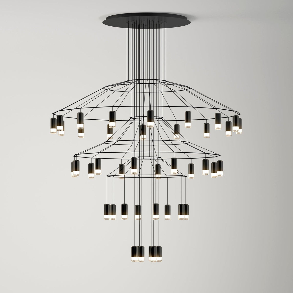 Three-tier Clérachic wire chandelier with ringed frames and LED drops stepping down towards a lit cluster at the bottom.
